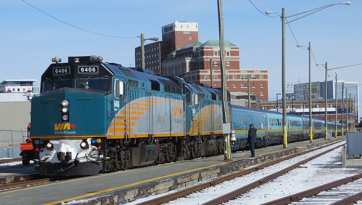 A VIA Rail train waits at a snow platform on a bright sunny day outside the train station in Halifax
