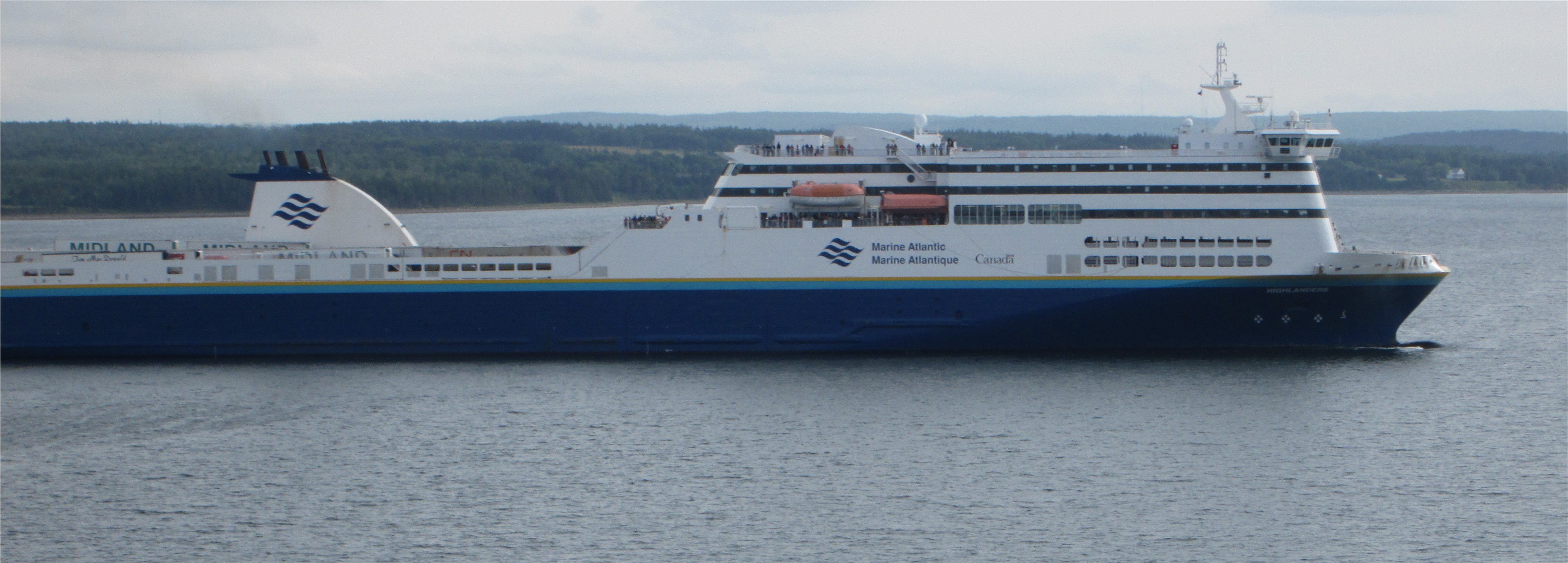 The Marine Atlantic Blue Puttees, a passenger and vehicle ferry, sails under an overcast sky
